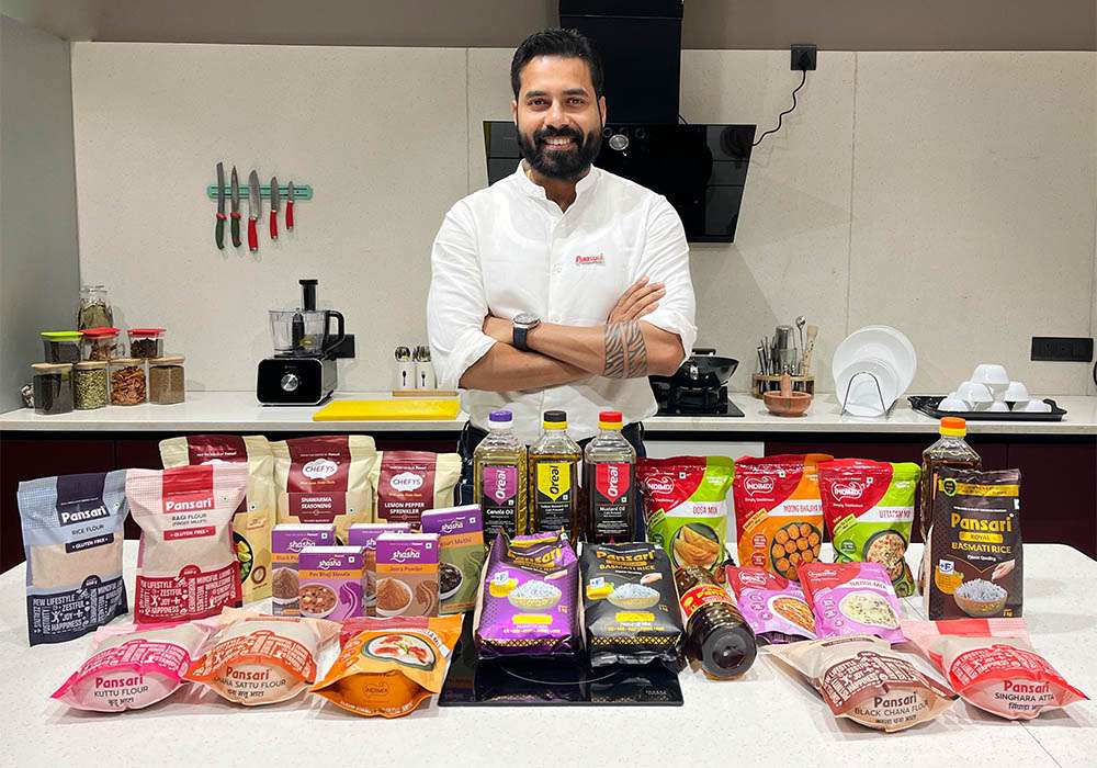 Chairman of Pansari Group standing with a wide range of Pansari food products